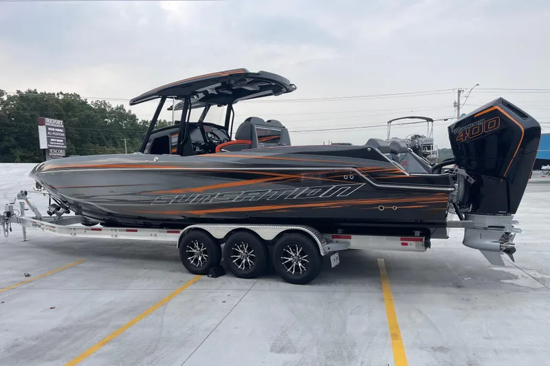 Slide: The Image of 2025 Sunsation 32 CCX boat on trailer, sleek design with powerful engine. - 7