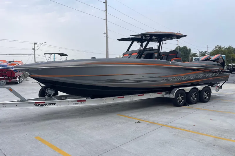 Slide: The Image of 2025 Sunsation 32 CCX boat on trailer, sleek design, parked outdoors. - 8