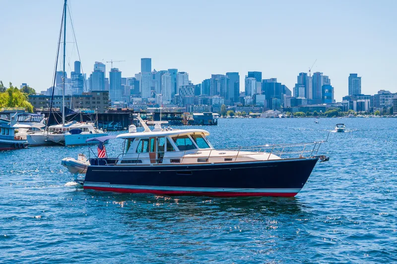 Slide: The Image of 2014 Sabre 48 Salon Express yacht cruising in urban waterfront with Seattle skyline backdrop. - 10