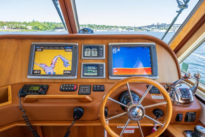 Slide: The Image of Helm of 2014 Sabre 48 Salon Express with navigation screens and steering wheel. - 12