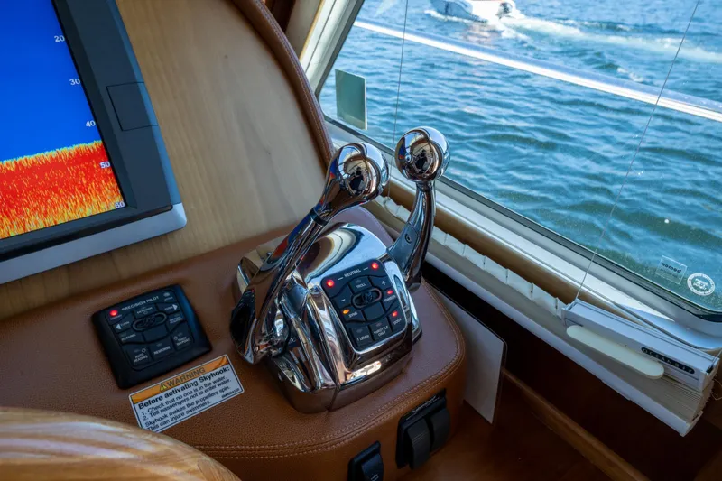 Slide: The Image of 2014 Sabre 48 Salon Express helm with controls and navigation display. - 14