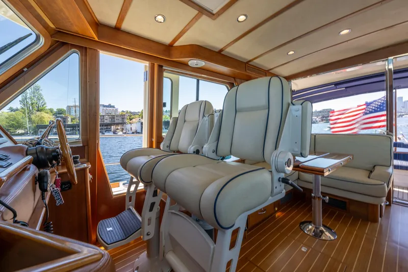 Slide: The Image of Interior of 2014 Sabre 48 Salon Express yacht with luxurious seating and American flag. - 16
