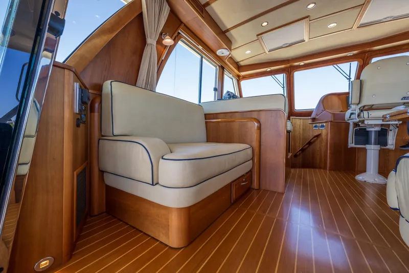 Slide: The Image of Interior of 2014 Sabre 48 Salon Express, featuring elegant wood finish and plush seating. - 19