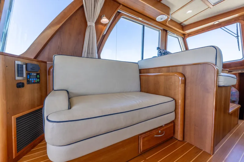 Slide: The Image of Interior of 2014 Sabre 48 Salon Express yacht with wooden finish and cushioned seating. - 20