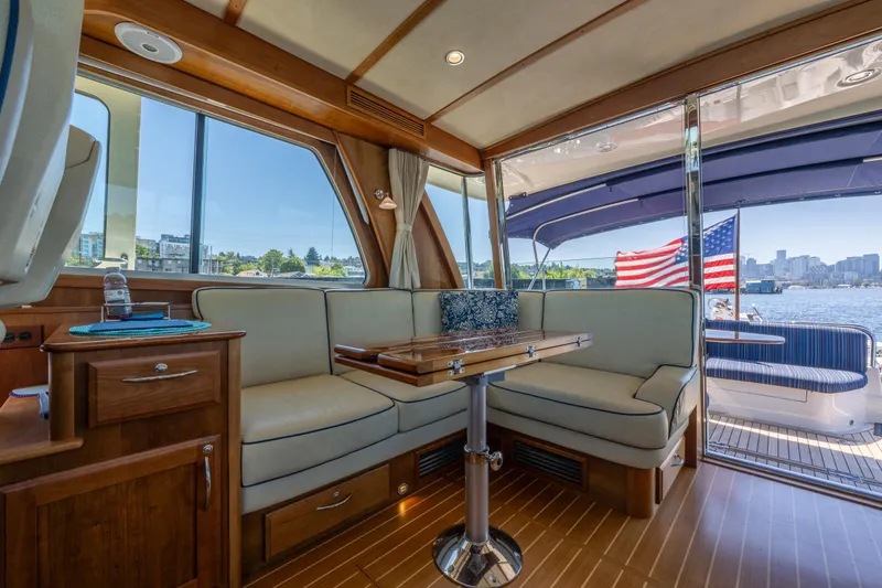 Slide: The Image of Interior of 2014 Sabre 48 Salon Express yacht with seating, table, and waterfront view. - 22