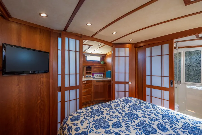 Slide: The Image of Luxurious 2014 Sabre 48 Salon Express interior with wood paneling and floral bedding. - 32