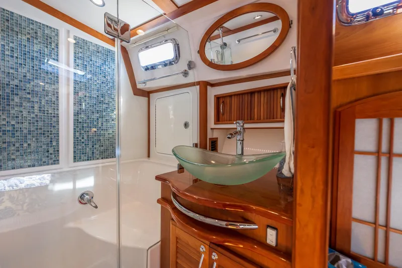 Slide: The Image of Luxurious bathroom in 2014 Sabre 48 Salon Express yacht with glass sink and mosaic tiles. - 33