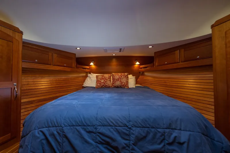 Slide: The Image of Luxurious cabin interior of 2014 Sabre 48 Salon Express with cozy bedding and wooden accents. - 36