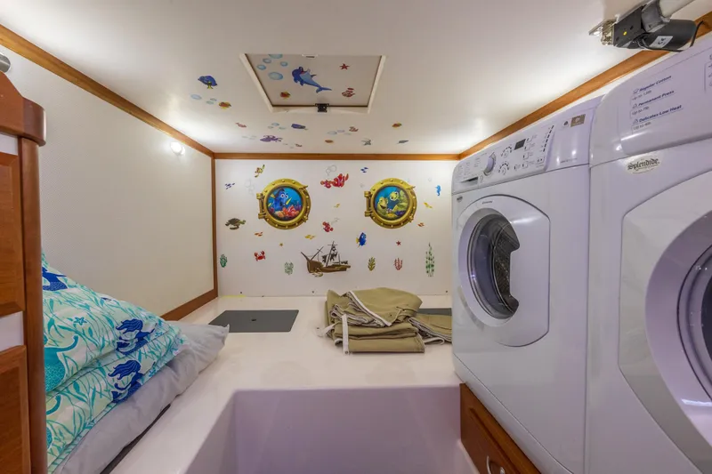 Slide: The Image of Laundry area in 2014 Sabre 48 Salon Express with nautical-themed decor. - 39