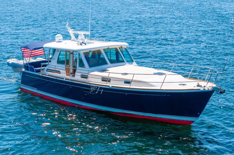 Slide: The Image of 2014 Sabre 48 Salon Express yacht on clear blue water. - 4