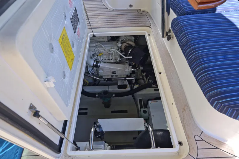 Slide: The Image of Engine compartment of 2014 Sabre 48 Salon Express yacht, showcasing mechanical components and seating area. - 41