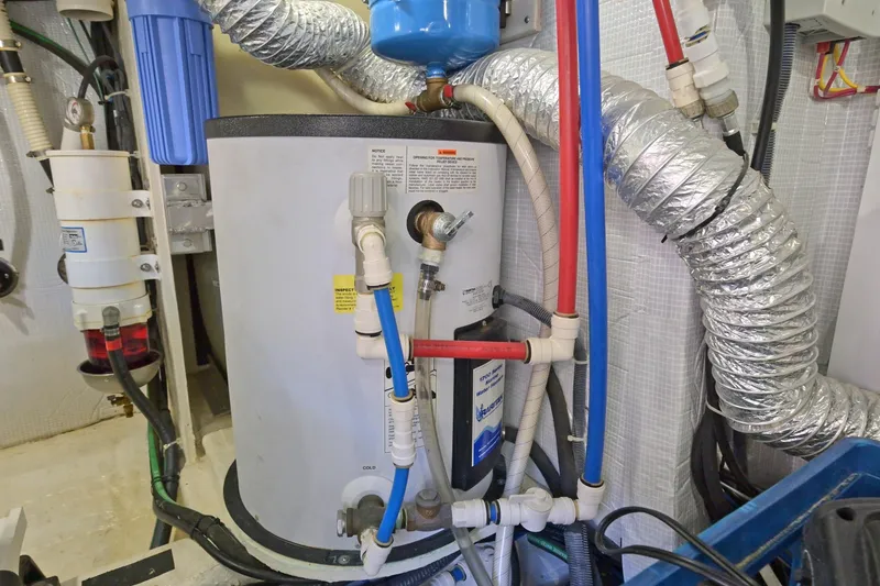 Slide: The Image of Engine room of 2014 Sabre 48 Salon Express with water heater and ductwork. - 43