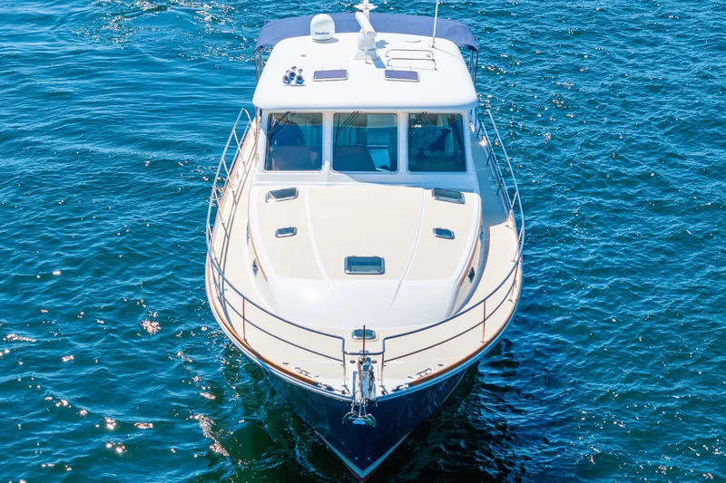 Slide: The Image of 2014 Sabre 48 Salon Express yacht cruising on blue water. - 6