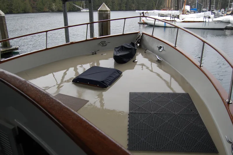 Slide: The Image of 1979 Ocean Alexander Mark 1 55 yacht deck with railing and docked sailboats. - 10