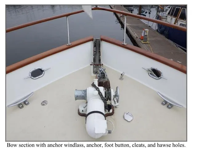 Slide: The Image of Bow of 1979 Ocean Alexander Mark 1 55 with anchor windlass, cleats, and hawse holes. - 11