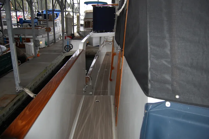 Slide: The Image of 1979 Ocean Alexander Mark 1 55 yacht docked, showing side deck and railing. - 12