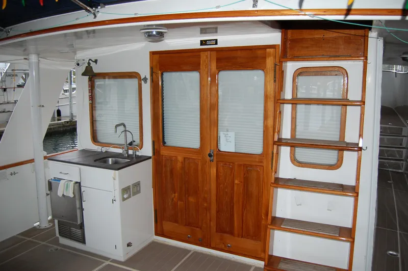 Slide: The Image of 1979 Ocean Alexander Mark 1 55 yacht interior with wooden doors and kitchenette. - 17