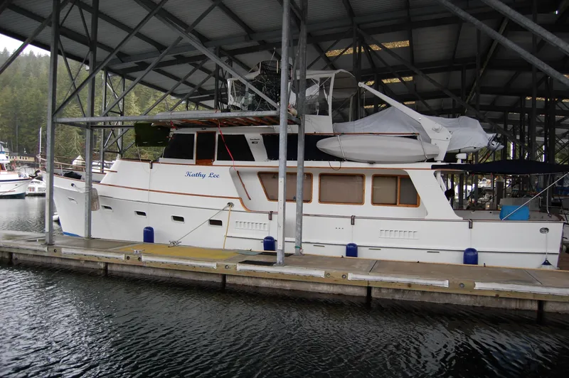 Slide: The Image of 1979 Ocean Alexander Mark 1 55 yacht docked under a covered marina. - 2