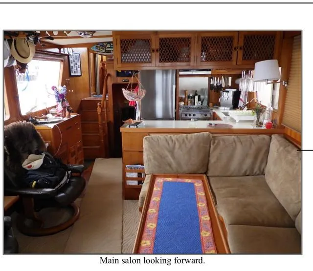 Slide: The Image of Main salon of 1979 Ocean Alexander Mark 1 55 yacht, featuring cozy seating and kitchen area. - 21