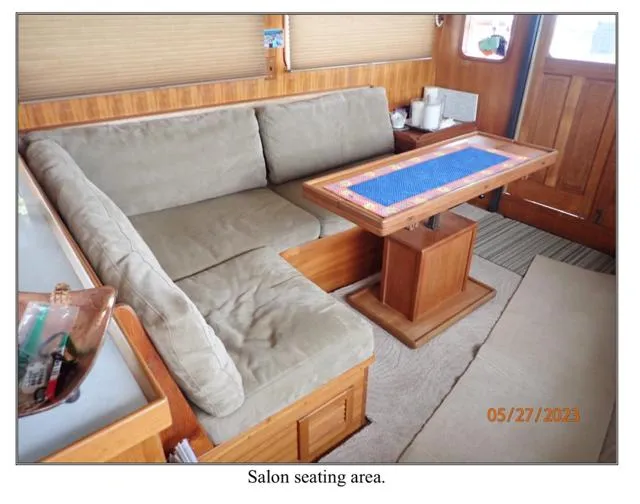 Slide: The Image of Salon seating area in 1979 Ocean Alexander Mark 1 55 yacht, featuring cozy cushions and wooden table. - 22