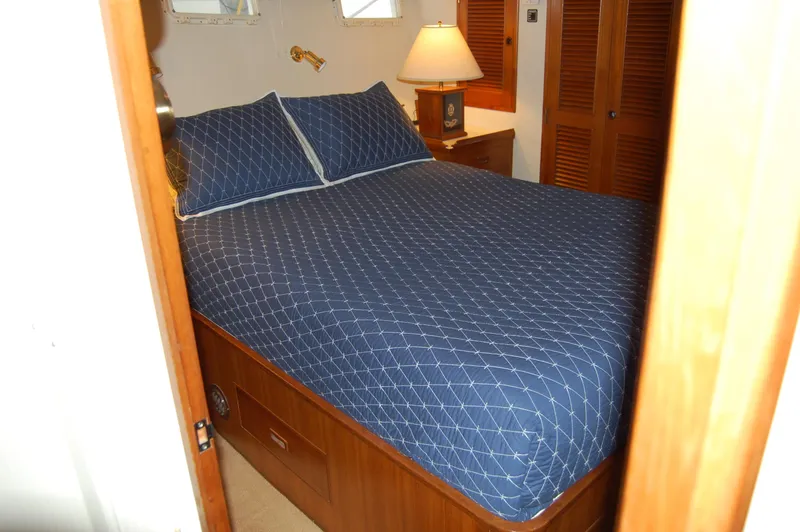 Slide: The Image of Cozy bedroom in 1979 Ocean Alexander Mark 1 55 yacht with blue bedding. - 30