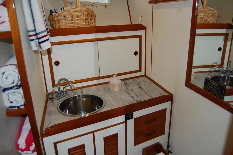 Slide: The Image of 1979 Ocean Alexander Mark 1 55 yacht bathroom with sink, marble countertop, and storage cabinets. - 31