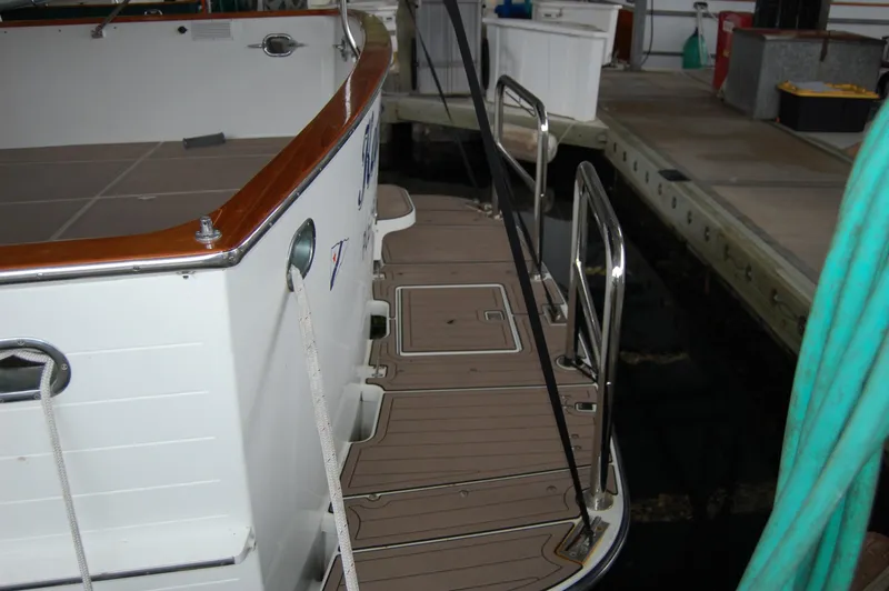 Slide: The Image of 1979 Ocean Alexander Mark 1 55 yacht docked, showing rear deck and railing. - 6