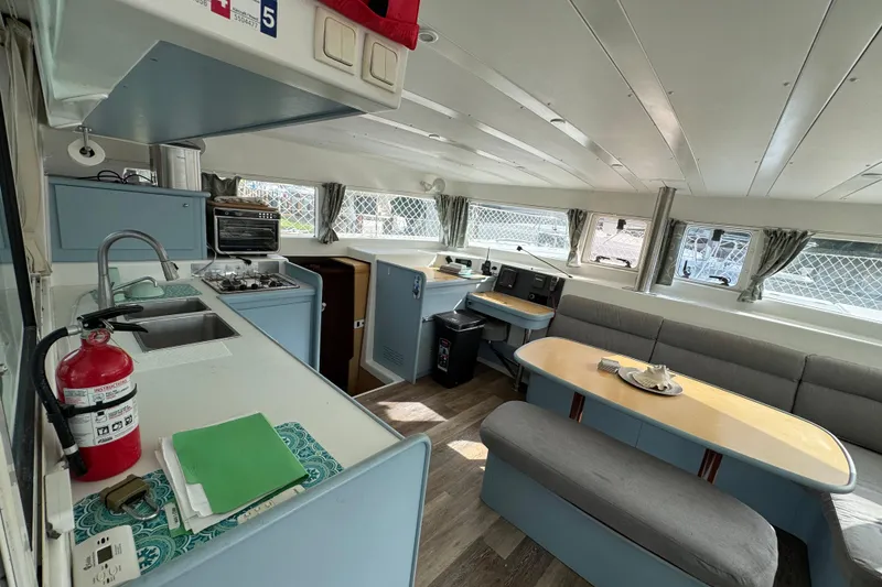 Slide: The Image of Interior of 2008 Lagoon 420 catamaran with kitchen and seating area. - 12