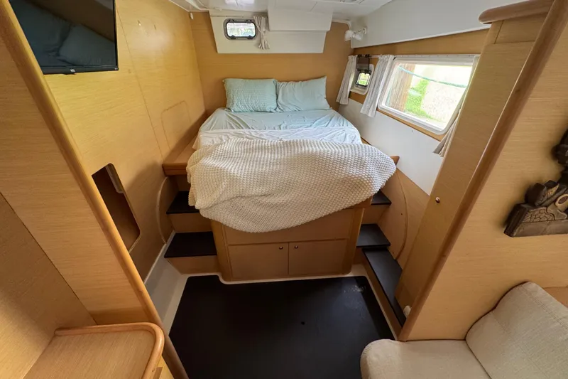 Slide: The Image of Interior of 2008 Lagoon 420 yacht cabin with cozy bed and wooden decor. - 18