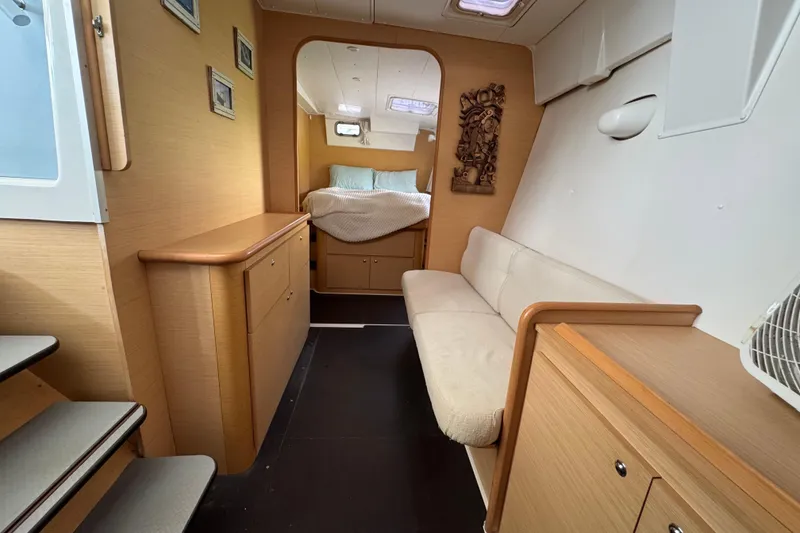 Slide: The Image of Interior of 2008 Lagoon 420 yacht with cozy seating and bedroom area. - 21