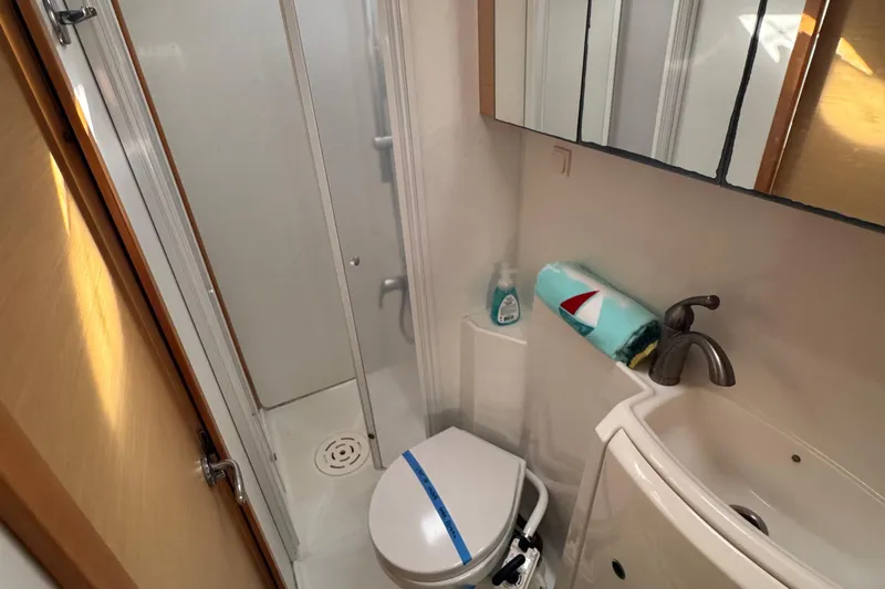 Slide: The Image of Compact bathroom in 2008 Lagoon 420 yacht with shower, toilet, and sink. - 23
