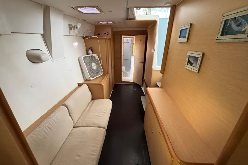 Slide: The Image of Interior of 2008 Lagoon 420 yacht with beige sofa and wooden cabinetry. - 28