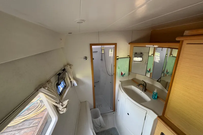 Slide: The Image of Interior of 2008 Lagoon 420 yacht bathroom with shower, sink, and mirror. - 30