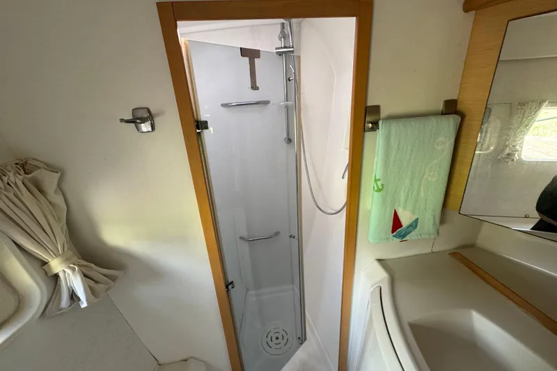 Slide: The Image of Compact bathroom in a 2008 Lagoon 420 yacht, featuring a shower and sink. - 31