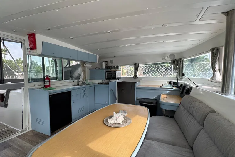 Slide: The Image of Interior of 2008 Lagoon 420 catamaran with kitchen, dining area, and navigation station. - 41