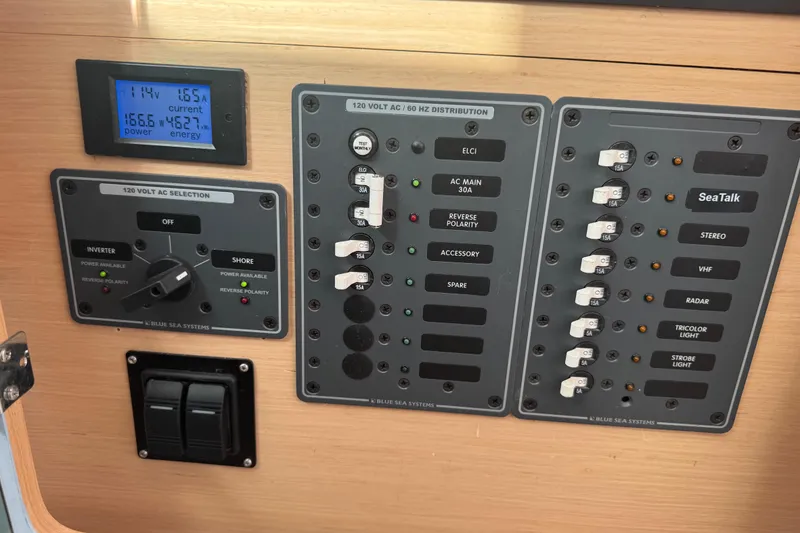 Slide: The Image of Electrical control panel on a 2008 Lagoon 420 yacht, featuring various switches and a digital display. - 44