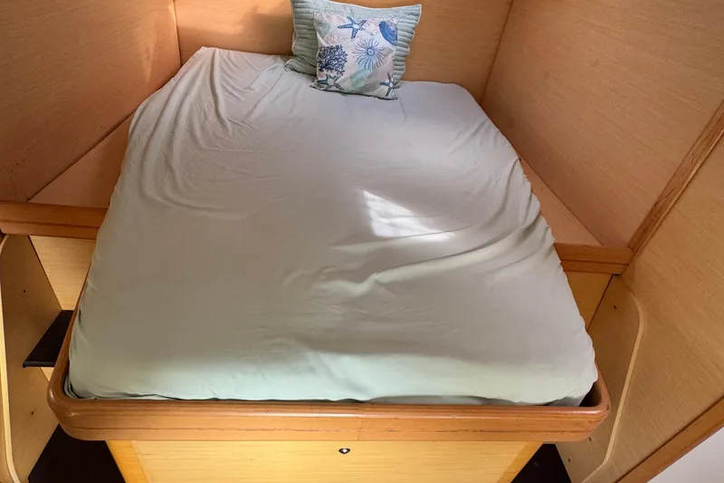Slide: The Image of Cozy cabin bed in a 2008 Lagoon 420 yacht with a decorative pillow. - 46