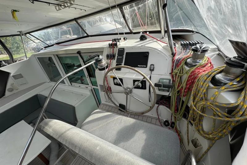 Slide: The Image of Cockpit of 2008 Lagoon 420 sailboat with steering wheel and navigation equipment. - 6