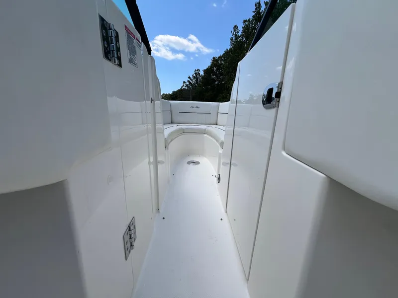 Slide: The Image of 2007 Sea Ray 270 SLX boat interior with white seating and clear blue sky. - 11