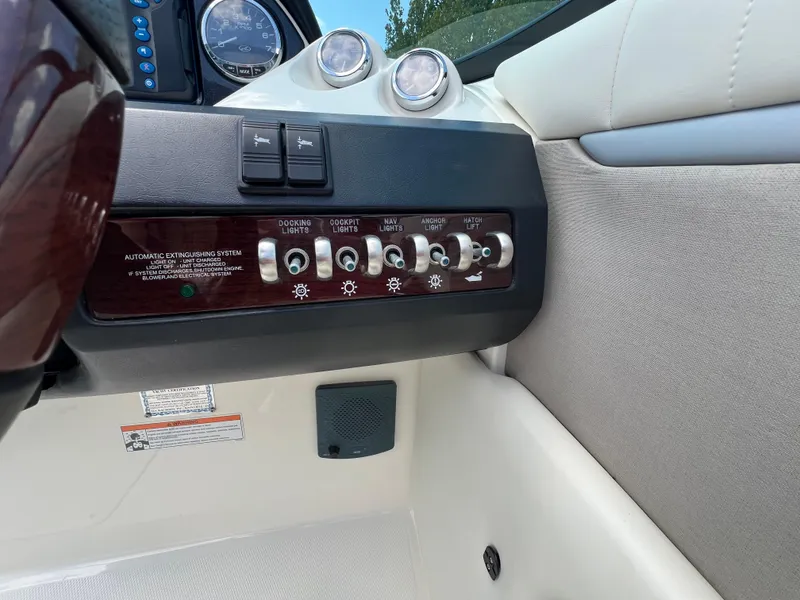 Slide: The Image of Control panel of a 2007 Sea Ray 270 SLX boat with various switches. - 14
