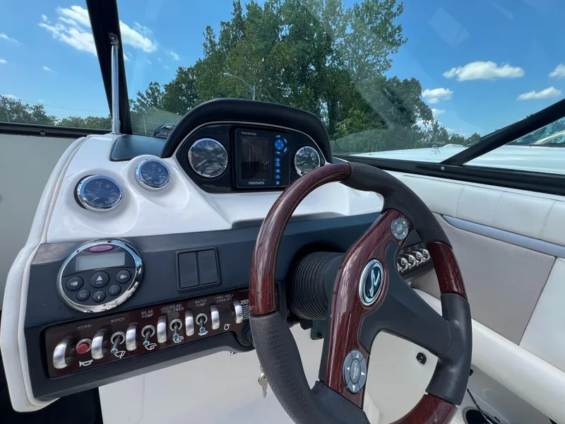 Slide: The Image of Dashboard of a 2007 Sea Ray 270 SLX boat with steering wheel and gauges. - 15