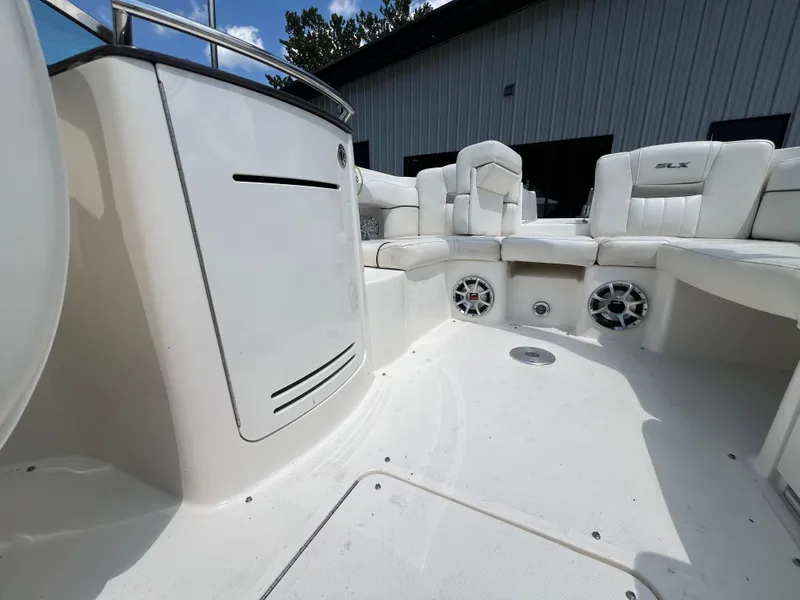 Slide: The Image of Interior of a 2007 Sea Ray 270 SLX boat with white seating and speakers. - 20