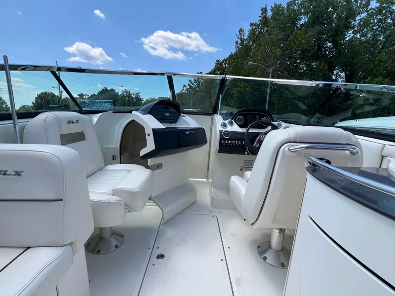 Slide: The Image of 2007 Sea Ray 270 SLX boat interior with white seating and steering console. - 7