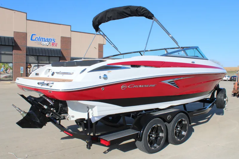 Slide: The Image of 2024 Crownline 240 SS boat with red and white design on a trailer. - 11