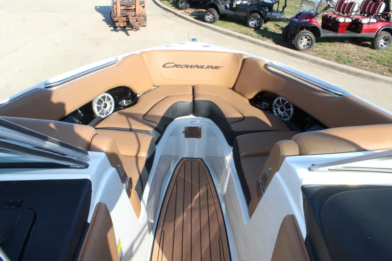 Slide: The Image of 2024 Crownline 240 SS boat interior with tan seating and wood accents. - 3