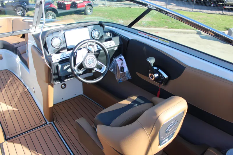 Slide: The Image of 2024 Crownline 240 SS boat interior with modern dashboard and steering wheel. - 4
