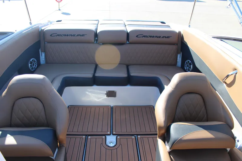 Slide: The Image of 2024 Crownline 240 SS boat interior with tan leather seating and wood accents. - 6