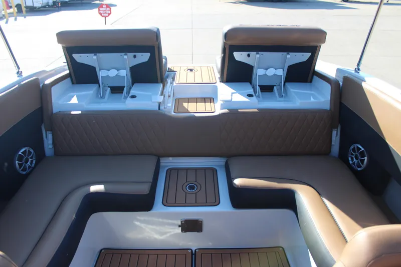 Slide: The Image of 2024 Crownline 240 SS boat interior with brown seating and modern design. - 7