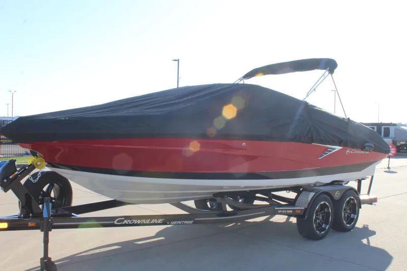 Slide: The Image of 2024 Crownline 240 SS boat with cover on trailer, red and black design. - 8