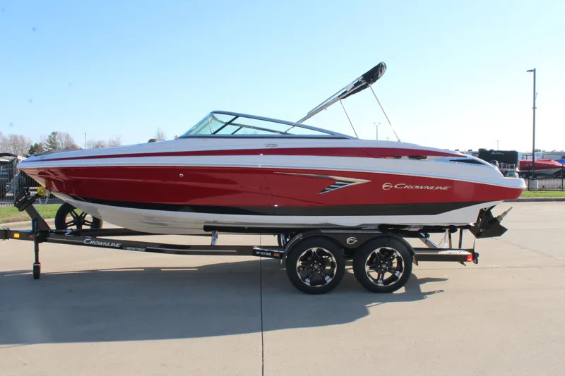 Slide: The Image of 2024 Crownline 240 SS boat in red on a trailer, side view. - 9